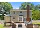 Back of the house with patio, fenced yard, outdoor furniture and a brick chimney at 10600 Four Mile Creek Rd, Charlotte, NC 28277