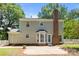 Back of house featuring a brick chimney, patio area, and fenced yard under a clear blue sky at 10600 Four Mile Creek Rd, Charlotte, NC 28277