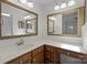 Bathroom featuring wood cabinets, marble countertops, and double mirrors at 10600 Four Mile Creek Rd, Charlotte, NC 28277