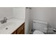 Clean bathroom with a white sink, wood cabinet, and toilet, featuring a simple and functional design at 10600 Four Mile Creek Rd, Charlotte, NC 28277