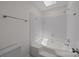 Bathroom featuring a built-in tub with tiled walls and modern shower head at 10600 Four Mile Creek Rd, Charlotte, NC 28277
