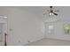 Spacious bedroom featuring neutral carpet, fan, and two bright windows at 10600 Four Mile Creek Rd, Charlotte, NC 28277