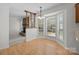 Bright dining area features hardwood floors, a bay window, and decorative columns near the cozy fireplace at 10600 Four Mile Creek Rd, Charlotte, NC 28277
