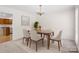 Formal dining room with chandelier and view into adjacent kitchen with wood cabinets at 10600 Four Mile Creek Rd, Charlotte, NC 28277