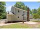 The exterior of the house shows a brick chimney, bay window, brick foundation, and a paved patio at 10600 Four Mile Creek Rd, Charlotte, NC 28277