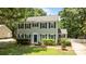 A two-story home features a tidy front yard, manicured shrubs, and shutters at 10600 Four Mile Creek Rd, Charlotte, NC 28277