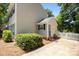This exterior is accented by green foliage, neutral siding, a covered entrance, and a concrete driveway at 10600 Four Mile Creek Rd, Charlotte, NC 28277