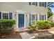 Charming home entrance with a blue front door, brick steps, and manicured shrubs, creating a welcoming curb appeal at 10600 Four Mile Creek Rd, Charlotte, NC 28277
