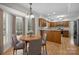 Open breakfast nook and kitchen with wood floors, and plenty of natural light at 10600 Four Mile Creek Rd, Charlotte, NC 28277