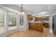 Bright kitchen and breakfast nook with natural light, warm wood cabinets, and stainless steel refrigerator at 10600 Four Mile Creek Rd, Charlotte, NC 28277