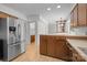 Well-equipped kitchen with stainless steel refrigerator, wood cabinetry, and an adjacent dining area for convenience at 10600 Four Mile Creek Rd, Charlotte, NC 28277