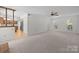 Open-concept living space with hardwood floors, a ceiling fan, and a glimpse of the adjoining kitchen at 10600 Four Mile Creek Rd, Charlotte, NC 28277