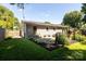 Landscaped backyard with a stone patio, lush greenery, and privacy fencing at 1114 Urban Pl, Charlotte, NC 28209