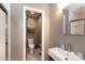 Modern half bathroom featuring a sink and toilet, complemented by neutral wall tones at 1114 Urban Pl, Charlotte, NC 28209
