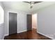 A bright bedroom with hardwood floors, windows and two dark colored doors at 1114 Urban Pl, Charlotte, NC 28209