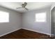 Bedroom with two windows, hardwood floors and a dark-colored door at 1114 Urban Pl, Charlotte, NC 28209