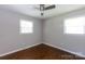 A simply designed bedroom with hardwood flooring, a ceiling fan, and two windows at 1114 Urban Pl, Charlotte, NC 28209