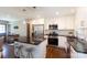 Modern kitchen featuring white cabinets, stainless steel appliances, granite countertops, and hardwood floors at 1114 Urban Pl, Charlotte, NC 28209