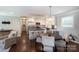 Open kitchen and dining area featuring a kitchen island, modern lighting, and stainless appliances at 1114 Urban Pl, Charlotte, NC 28209