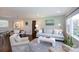 Bright and airy living room with hardwood floors, neutral decor, and seamless flow to the dining area at 1114 Urban Pl, Charlotte, NC 28209