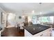 Bright open-concept living space with seamless flow between kitchen, dining, and living areas, plus hardwood floors at 1114 Urban Pl, Charlotte, NC 28209