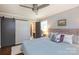 Well lit bedroom featuring hardwood floors, neutral paint, sliding door access, and an ensuite bathroom at 1114 Urban Pl, Charlotte, NC 28209