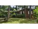 Quaint brick house with mature trees and a picnic table sitting in the front yard at 1116 Bryce Ave, Salisbury, NC 28144