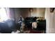 Disorganized living room with an old TV, a sofa, an exercise bike, and scattered items at 1116 Bryce Ave, Salisbury, NC 28144