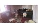 Disorganized living room featuring a sofa, an exercise bike, and an old TV at 1116 Bryce Ave, Salisbury, NC 28144