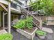 Backyard featuring stairs to a deck, a raised garden bed, and decorative landscaping at 1118 Yale Pl, Charlotte, NC 28209