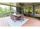 Large covered deck with wood flooring, an outdoor dining set, and inviting rocking chairs at 1118 Yale Pl, Charlotte, NC 28209
