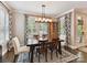 Elegant dining room features a wooden table, large windows, and stylish light fixture at 1118 Yale Pl, Charlotte, NC 28209