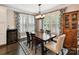 Charming dining area featuring stylish lighting, large windows, and a wine cooler at 1118 Yale Pl, Charlotte, NC 28209