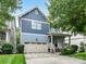 Charming two-story home with blue siding, a two-car garage, and a welcoming front porch at 1118 Yale Pl, Charlotte, NC 28209