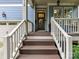 The front porch has brown stairs, white railings, and a welcoming wreath on the front door at 1118 Yale Pl, Charlotte, NC 28209