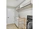 Efficient laundry room features tile floor, modern machines, storage shelves and utility sink at 1118 Yale Pl, Charlotte, NC 28209