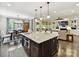 Bright, open-concept living room features a kitchen island, dining area, and cozy fireplace with built-ins at 1118 Yale Pl, Charlotte, NC 28209