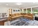 Spacious living room features oversized sofa, hardwood floor, and an area rug at 1118 Yale Pl, Charlotte, NC 28209