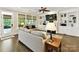 Comfortable living room with built-in shelving, decorative fireplace, and serene backyard views at 1118 Yale Pl, Charlotte, NC 28209