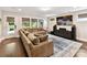 Cozy living room provides plush seating, media center, and outdoor views through sunlit windows at 1118 Yale Pl, Charlotte, NC 28209