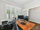 Home office with large window, white shutters, wood desk and contemporary furniture at 1118 Yale Pl, Charlotte, NC 28209