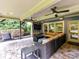 Cozy covered patio featuring outdoor seating, a fire table, and a ceiling fan for relaxing enjoyment at 1118 Yale Pl, Charlotte, NC 28209