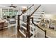 Elegant staircase featuring dark wood treads, white risers, and mountain-themed artwork at 1118 Yale Pl, Charlotte, NC 28209