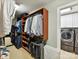 Large walk-in closet features custom shelving and hanging space and leads to laundry room at 1118 Yale Pl, Charlotte, NC 28209