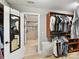 Spacious walk-in closet with custom shelving and storage opens to luxurious shower at 1118 Yale Pl, Charlotte, NC 28209