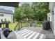 Relax on this back deck with its blue chairs, outdoor rug and grill, perfect for entertaining or unwinding at 12411 Herdon Ct, Charlotte, NC 28277