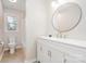 Bathroom with white vanity, tan tile flooring, and toilet with shower and window in background at 12411 Herdon Ct, Charlotte, NC 28277