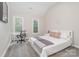 Bedroom featuring a cozy workspace, natural light, and plush carpet flooring, offering a comfortable environment at 12411 Herdon Ct, Charlotte, NC 28277