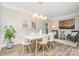 Elegant dining room with modern lighting, stylish seating, and sophisticated decor at 12411 Herdon Ct, Charlotte, NC 28277