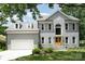 Charming two-story home with a well-maintained lawn, attached garage, and beautiful architectural details at 12411 Herdon Ct, Charlotte, NC 28277